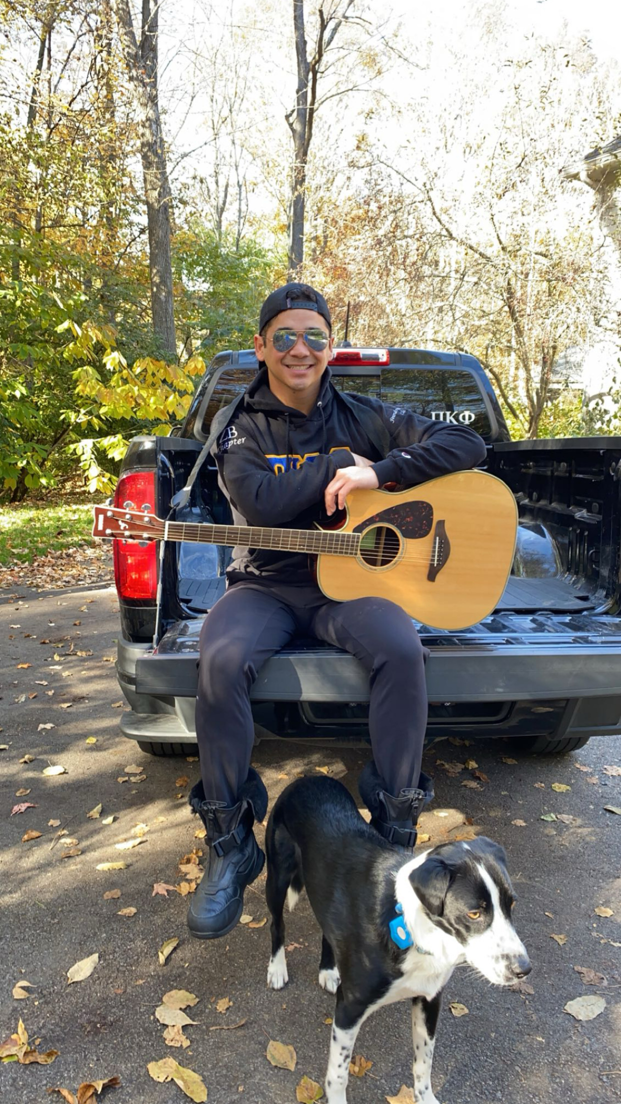 Joe Giltner with a dog and guitar